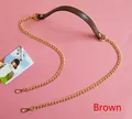 Detail of dark brown leather handbag strap with gold metal chains and lobster clasps - Brown
