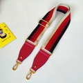 Detail of adjustable wide nylon bag strap with colorful stripes and gold metal hooks - Red Stripe With Rose Red Leather
