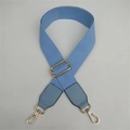 Close-up of light blue woven strap with gold metal buckles and PU leather reinforcements - Light Blue