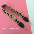 Detail of adjustable khaki wide shoulder strap with black lettering and gold hooks - Style 1 Square Gold Buckle