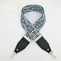 Close-up of geometric ethnic pattern bag strap with gold metal hardware and leather ends - Gallery
