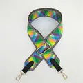 Detail showing colorful geometric wide strap with gold metal hooks and leather accents - Rainbow Geometric