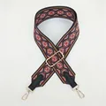 Macro detail of bohemian geometric woven purse strap with gold metal hooks - Red Bohemian