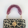 Leopard print handbag featuring a plush purple faux fur handle and golden metal clasp - Variegated Wine Red