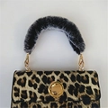 Leopard print handbag featuring a black faux fur handle and gold metal twist lock - Variegated Black
