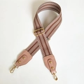 Detail of adjustable chevron woven strap with pink leather ends and gold metal hardware - Khaki Strap with Light Pink End