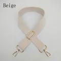 Close-up of adjustable beige woven bag strap with premium gold metal lobster clasps - Off White