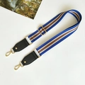 Detail of multi-color striped wide nylon shoulder strap with gold metal hooks and leather finish - Sky Blue with Black Leather