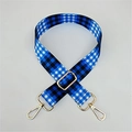 Close-up of adjustable blue and black gingham canvas bag strap with gold metal hardware - Light Blue