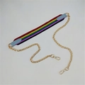 Close-up of rainbow woven canvas bag strap with light blue leather ends and gold hardware - No.29 Light Blue Colorful Stripes