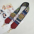 Detail of colorful geometric woven bag strap with golden metal swivel lobster clasps - Burgundy