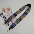 Close-up of ethnic style embroidered bag strap with golden metal lobster clasps - Green