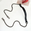 Detail of black metal handbag chain strap with leather shoulder pad and lobster clasps - Cross Black + Gold Chain