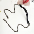 Close-up of black PU leather shoulder strap with gunmetal gray chain and spring buckles - Mirror Black + Gold Chain