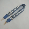 Detail view of adjustable light blue woven shoulder strap with gold metal hooks and leather trim - Lake Blue