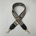 Detail of adjustable black and white jacquard wide shoulder strap with golden metal hooks - Letter Pattern Black Leather