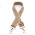 Close-up of khaki wide fabric strap with golden metal lobster clasps and buckle - Apricot