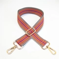 Close-up of adjustable geometric striped bag strap with gold metal lobster clasps - Orange