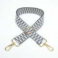 Detail of adjustable woven bag strap featuring black and white geometric wave patterns - Gray