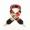 Detail of wide woven strap with abstract camo pattern and golden metal hardware - Orange Camouflage With Black Leather