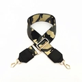 Detailed view of adjustable wide fabric shoulder strap with ethnic pattern and gold buckles - Gray Camouflage With Black Leather