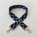 Close-up of No. 94 ethnic style woven strap with floral patterns and gold metal buckles - No. 94 Gold Buckle