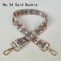 Close-up of ethnic style fabric shoulder strap with floral patterns and gold buckles - No. 34 Gold Buckle