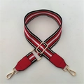 Detail of red, white and black striped adjustable handbag strap with gold metal hooks - Red Strap + Red Leather