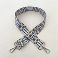 Detail view of woven bag strap with blue and yellow wave patterns and silver lobster clasps - Style 60 Silver Buckle