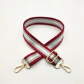 Detail of red and silver striped bag strap with premium gold metal swivel hooks and buckles - Burgundy