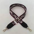 Detail of adjustable woven handbag strap with monogram pattern and metal lobster clasp - Red Gold Pattern + Black Leather