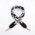 Close-up of leopard print strap with adjustable gold metal buckle and leather ends - White