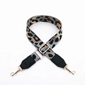 Close-up of leopard print bag strap with adjustable gold buckle and swivel lobster hooks - Gray