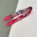 Detail showing tropical floral pattern on wide fabric bag strap with golden lobster hooks - Rose Floral + Rose Red Leather