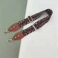 Detail of adjustable leopard print bag strap with gold metal hooks and leather accents - Leopard + Brown Leather