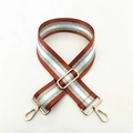 Macro view of adjustable brown and silver striped strap with golden lobster clasps - Brown
