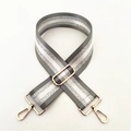 Close-up of adjustable striped nylon strap with silver glitter and gold metal clasps - Gray