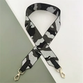 Macro shot of stylish camouflage bag strap with black leather ends and golden metal hooks - Camouflage Silver