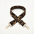 Macro detail of leopard print adjustable shoulder strap with gold metal lobster clasps - Brown