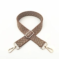 Macro detail of adjustable brown chevron pattern bag strap with gold metal lobster hooks - Khaki
