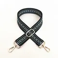 Close-up of thick ethnic style woven bag strap with green V-pattern and gold hardware - Style 4