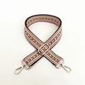 Close-up of ethnic geometric jacquard strap with golden lobster clasps and metal buckle - Style 8