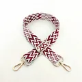 Detail view of ethnic red and white geometric woven strap with golden metal hook - Silver Clasp / No.3 Wine Red