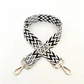 Close-up of No. 5 black and white geometric jacquard strap with gold metal hooks - Silver Clasp / No. 5 Coffee White