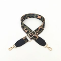 Detail of adjustable leopard print bag strap with golden metal hardware and black leather ends - Green