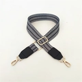 Detail of adjustable woven shoulder strap with black geometric pattern and gold hardware - Wheat Pattern & Black Leather