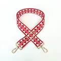 Detail view of red and white geometric woven shoulder strap with gold metal buckles - Silver Clasp / Red Rhombus