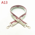 Close-up of pink wave pattern wide fabric strap with adjustable golden metal buckle - A13