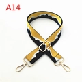 Close-up of adjustable woven bag strap featuring a yellow and black mountain landscape pattern - A14
