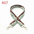 Detail view of adjustable canvas shoulder strap with wave pattern and golden metal hooks - A17